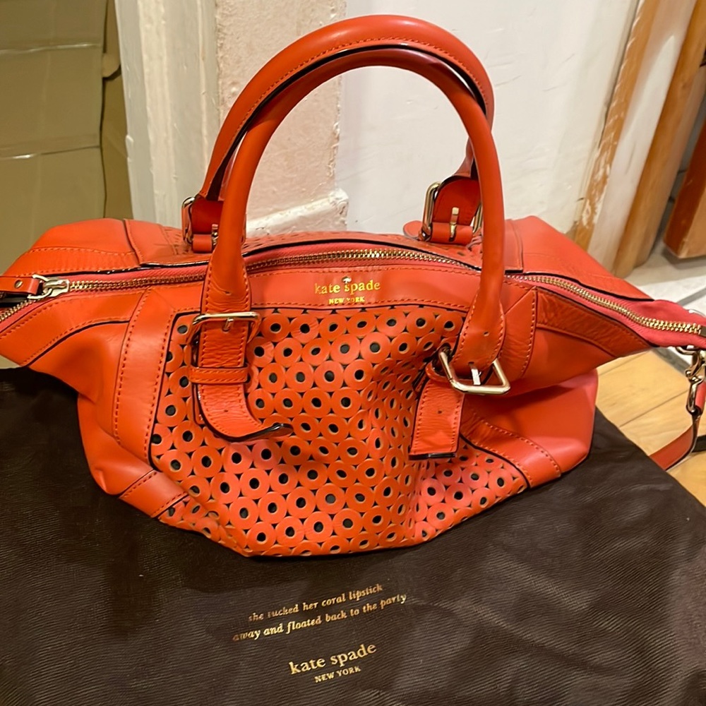 Cheerful orange Kate Spade bag with unique leather cut outs!